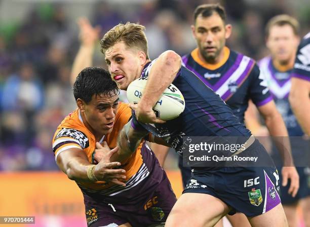 Cameron Munster of the Storm breaks through a tackle during the round 14 NRL match between the Melbourne Storm and the Brisbane Broncos at AAMI Park...