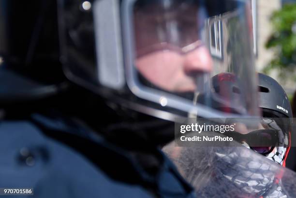 Masked protester making eye contact with the riot police during a rally to protest the G7 summit in Quebec City, Canada on 9 June 2018. During the...