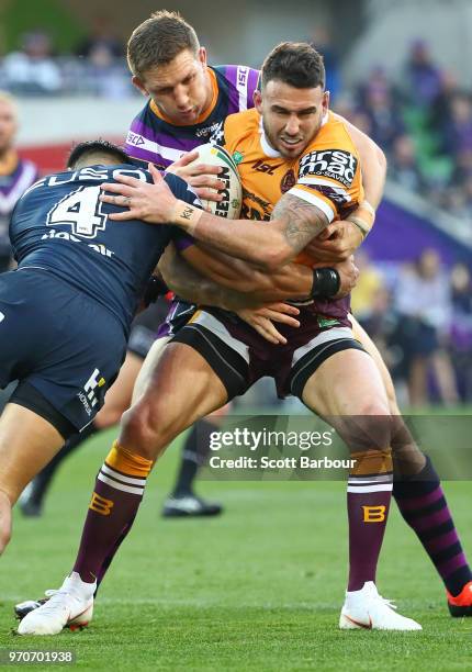 Darius Boyd of the Broncos is tackled during the round 14 NRL match between the Melbourne Storm and the Brisbane Broncos at AAMI Park on June 10,...