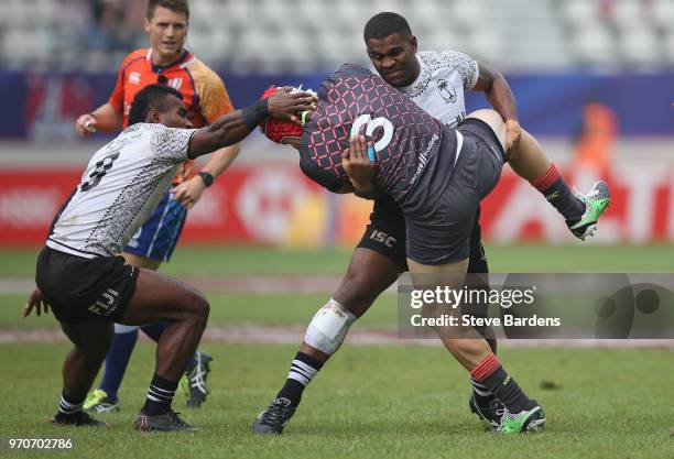 Phil Burgess of England is tackled by Vatemo Ravouvou of Fiji during the Cup quarter final match between Fiji and England during the HSBC Paris...