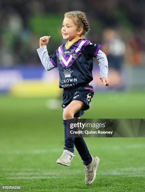 Matilda Smith the daughter of Cameron Smith and the ball kid celebrates a field kick by her father during the round 14 NRL match between the...