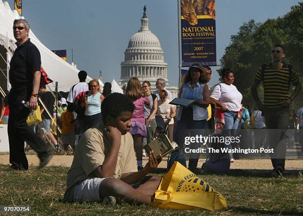 The National Mall Oblivious to the crowd milling around him Matthew Mayfield-Brown reads a book seated on a grassy patch on the National Mall....