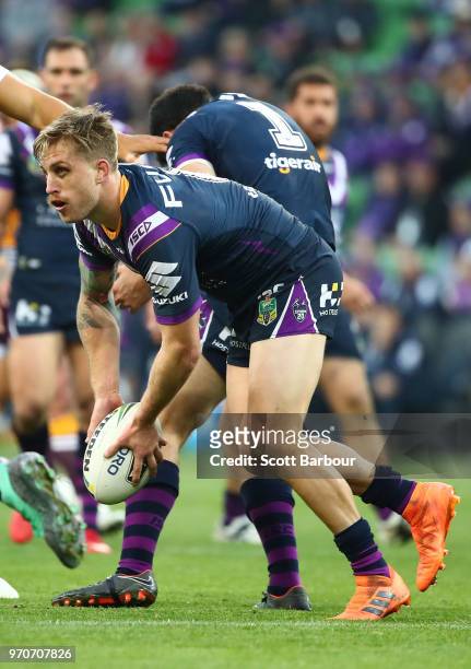 Cameron Munster of the Melbourne Storm runs with the ball during the round 14 NRL match between the Melbourne Storm and the Brisbane Broncos at AAMI...
