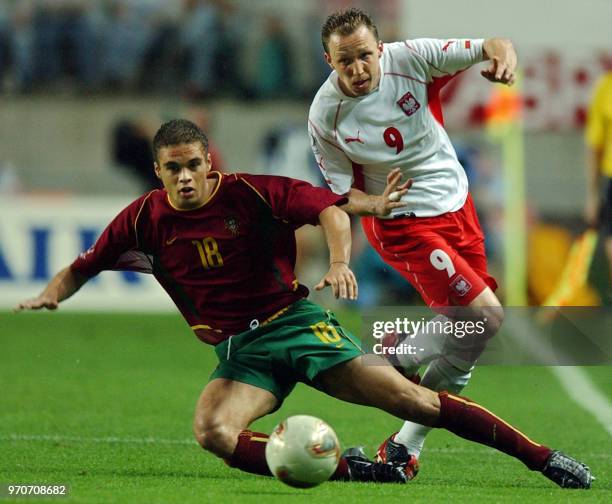 Poland's Pawel Kryszalowicz vies for the ball with Portugal's Frechaut , 10 June 2002 at the Jeonju World Cup Stadium in Jeonju, during first round...