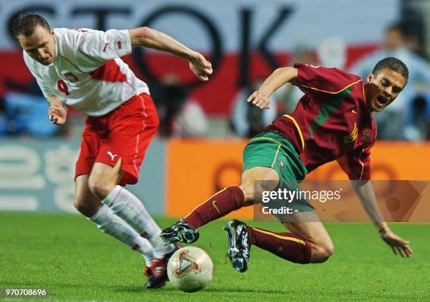 Portugal's Frechaut vies for the ball with Pawel Kryszalowicz of Poland , 10 June 2002 at the Jeonju World Cup Stadium in Jeonju, during first round...