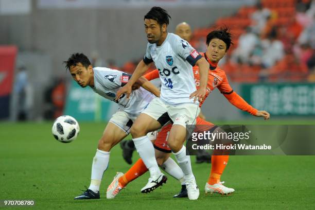 Kazuhito Watanabe of Yokohama FC and Genki Omae of Omiya Ardija compete for the ball during the J.League J2 match between Omiya Ardija and Yokohama...