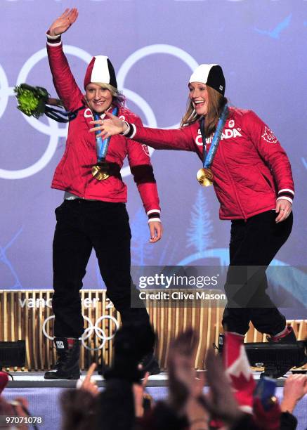 Kaillie Humphries and Heather Moyse of Canada celebrate receiving the gold medal during the medal ceremony for the women's bobsleigh on day 14 of the...