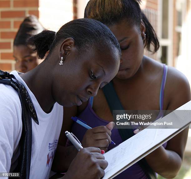 Kevin Clark/The Washington Post Neg #: 194335 Washington, DC Michelle Rawlins, left, and Sabrina Nivens sign a card at the site of a make-shift...