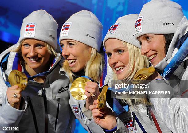 Norway's gold medalists Vibeke W Skofterud, Therese Johaug, Kristin Stoemer Steira and Marit Bjoergen attend the medal ceremony for the women's...