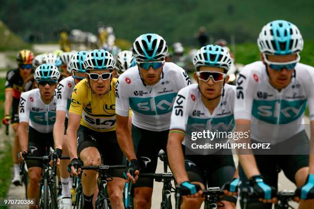 Britain's Geraint Thomas , wearing the overall leader's yellow jersey, rides in the pack chasing a 6-men breakaway, with his Great Britain's Sky...