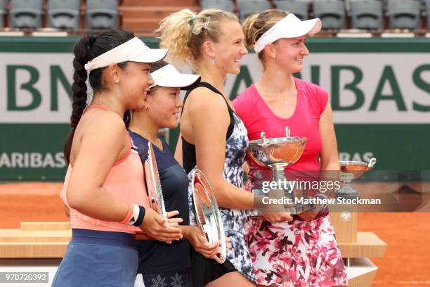 Barbora Krejcikova and partner Katerina Siniakova of the Czech Republic and Eri Hozumi and her partner Makoto Ninomiya of Japan celebrate with their...