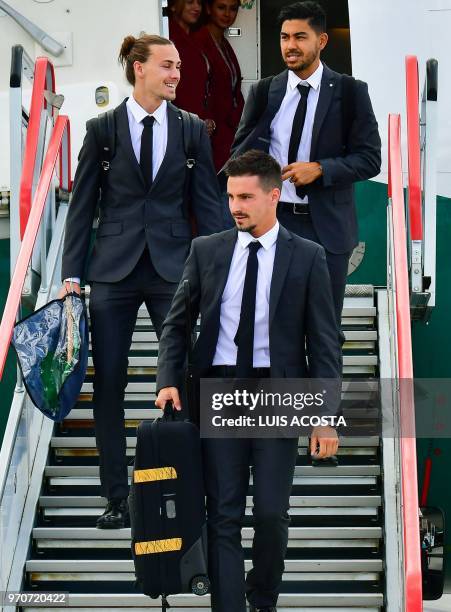 Australia football team's players Dimitri Petratos Jackson Irvine and Aziz Behich disembark from an airplane as they arrive at Kazan airport on June...