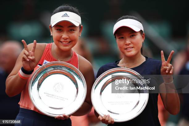 Eri Hozumi and Makoto Ninomiya of Japanpose with their runners up trophies after their Women's Doubles Final match against Katerina Siniakova; and...