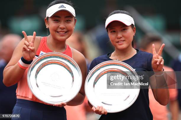 Eri Hozumi and Makoto Ninomiya of Japanpose with their runners up trophies after their Women's Doubles Final match against Katerina Siniakova; and...