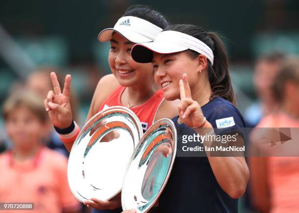 Eri Hozumi and Makoto Ninomiya of Japanpose with their runners up trophies after their Women's Doubles Final match against Katerina Siniakova; and...