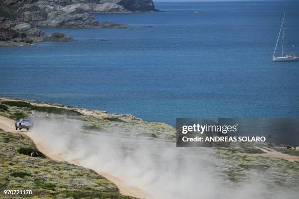 Hayden Paddon from New Zealand and co-driver Britain's Sebastian Marshall steer their Hyundai N i20 Coupe WRC, during the race at Argentiera, near...