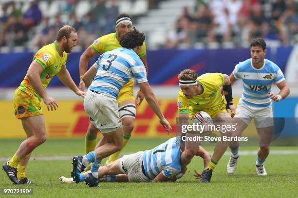 Ben O'Donnell of Australia is tackled by Lautaro Bazan Velez of Argentina during the Trophy semi final match between Argentina and Australia during...