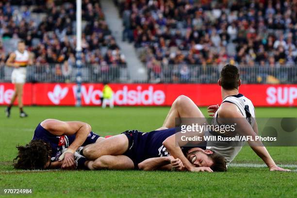 Alex Pearce and Joel Hamling of the Dockers lie on the ground after running into each other during the round 12 AFL match between the Fremantle...