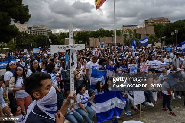 People holding Nicaraguan flags attend a demonstration to protest againt the political situation in Nicaragua at the Colon square in Madrid on June...