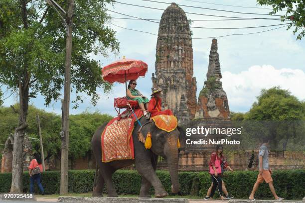 Tourists getting an elephone ride in Ayutthaya Old City. On Sunday, June 10 in Ayutthaya, Ayutthaya Province, Thailand.