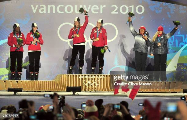 Shelly-Ann Brown and Helen Upperton of Canada receive the silver medal, Heather Moyse and Kaillie Humphries of Canada receive the gold medal and...