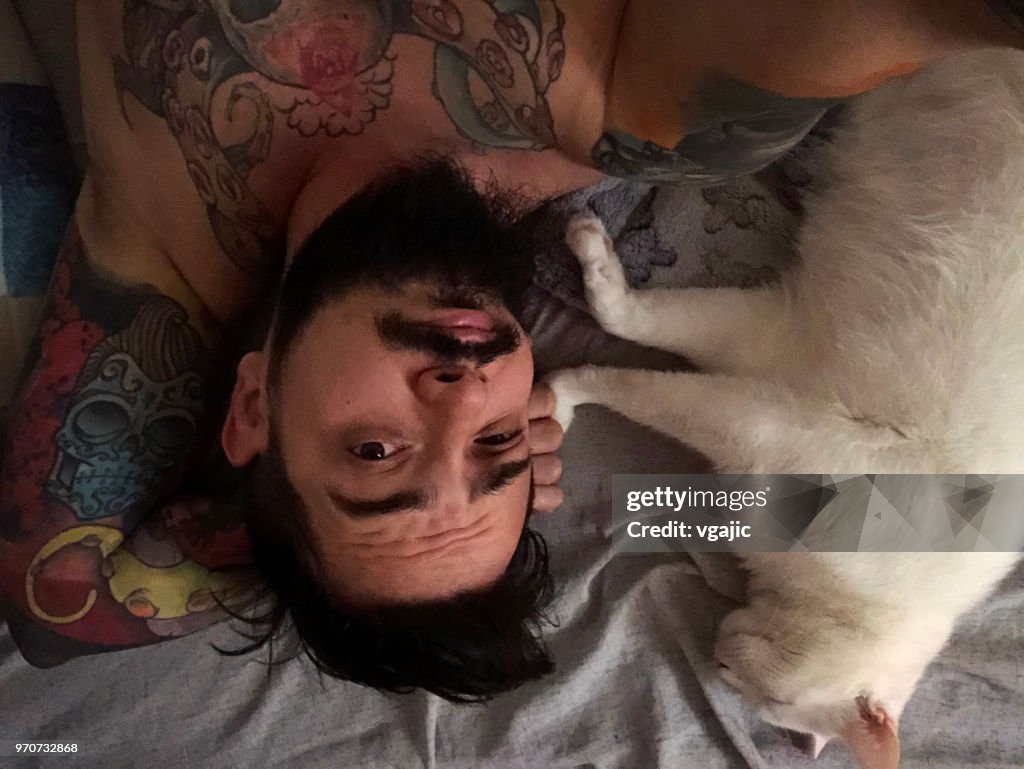Man With White Cat In Bed