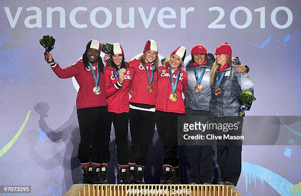 Shelly-Ann Brown and Helen Upperton of Canada receive the silver medal, Heather Moyse and Kaillie Humphries of Canada receive the gold medal and...