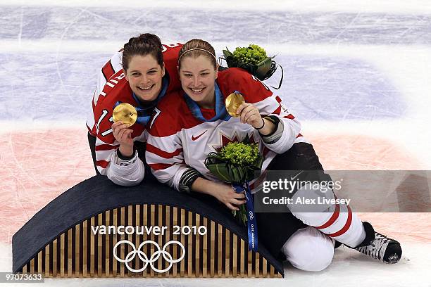 Jennifer Botterill and Cherie Piper of Canada pose with the gold medals following their team's 2-0 during the ice hockey women's gold medal game...