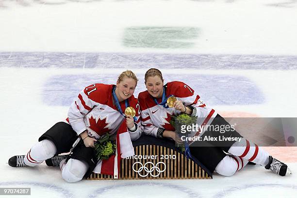 Haley Irwin and Cherie Piper of Canada pose with the gold medals following their team's 2-0 during the ice hockey women's gold medal game between...
