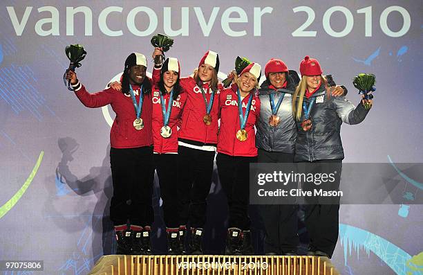 Shelly-Ann Brown and Helen Upperton of Canada receive the silver medal, Heather Moyse and Kaillie Humphries of Canada receive the gold medal and...