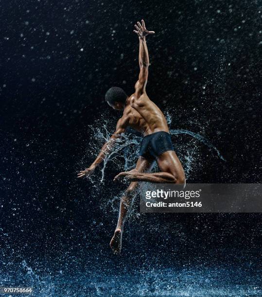 athletic ballet dancer performing with water - dancing in the rain stock pictures, royalty-free photos & images