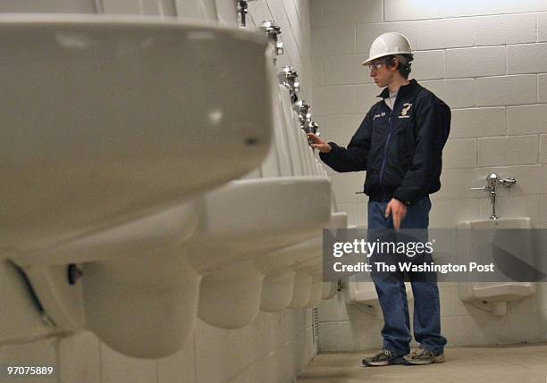 Volunteers help engineers at the new ballpark to test the plumbing by conducting a synchronized mass flushing exercise. Pictured, volunteer Jack...