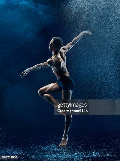 athletic ballet dancer performing with water - male gymnast stock pictures, royalty-free photos & images