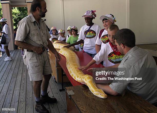 Reptile DATE: July12, 2007 CREDIT: Carol Guzy/ The Washington Post Triangle VA Children from Survivor Prince William day camp touch a large Indian...