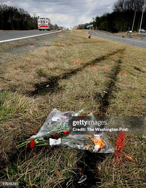 PGstreets Photos by Michael Williamson NEG#198226 2/19/08: Flowers mark the site of the tragic drag race accident in Accokeek, MD. Note skid marks...