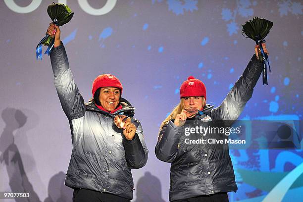 Elana Meyers and Erin Pac of the United States celebrate receiving the bronze medal during the medal ceremony for the women's bobsleigh on day 14 of...