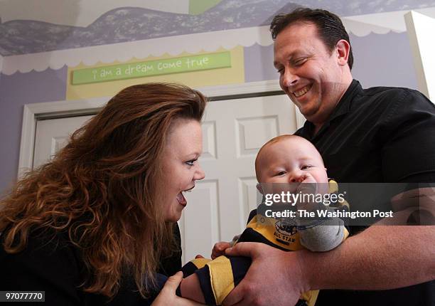 Tracy A. Woodward/The Washington Post Hubbard Court, Stafford, VA Gar-Field football coach Joe Mangano, wife Heather and son Jake, 5 1/2 months old....