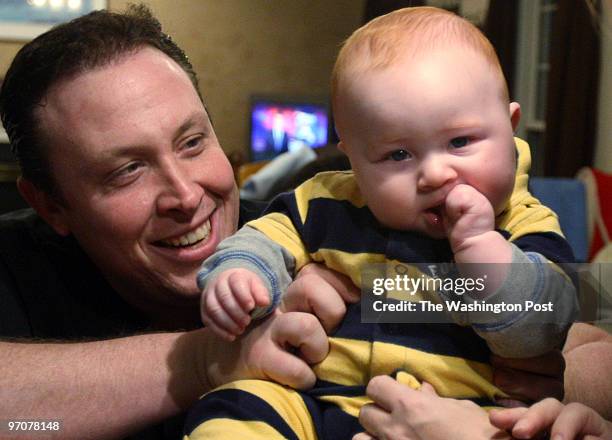 Tracy A. Woodward/The Washington Post Hubbard Court, Stafford, VA Gar-Field football coach Joe Mangano, wife Heather and son Jake, 5 1/2 months old....