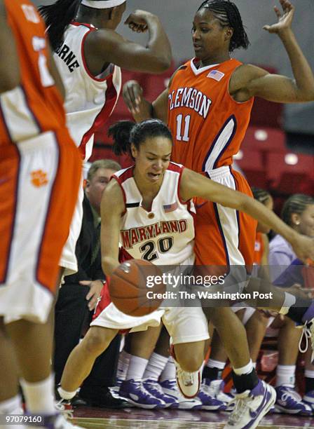 Maryland Women vs. Clemson in college basketball. Pictured, Maryland's Kristy Toliver threads her way between teammate Crystal Langhorne, left, and...