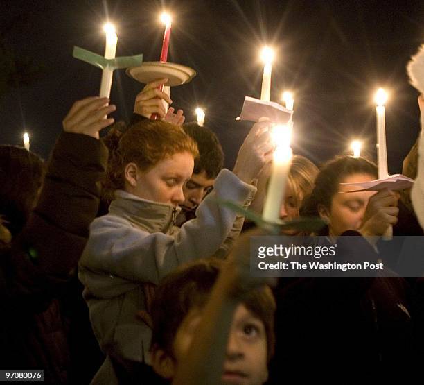 Kevin Clark/TWP Neg #: 196075 Rockville, MD Friends raise their candles to remember Ricardo Orellana and Oswald Rosales during the candle light vigil...