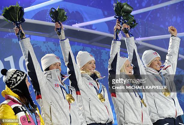 Norway's gold medalists Vibeke W Skofterud, Therese Johaug, Kristin Stoemer Steira and Marit Bjoergen attend the medal ceremony for the women's...