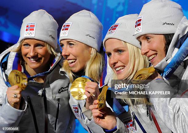 Norway's gold medalists Vibeke W Skofterud, Therese Johaug, Kristin Stoemer Steira and Marit Bjoergen attend the medal ceremony for the women's...