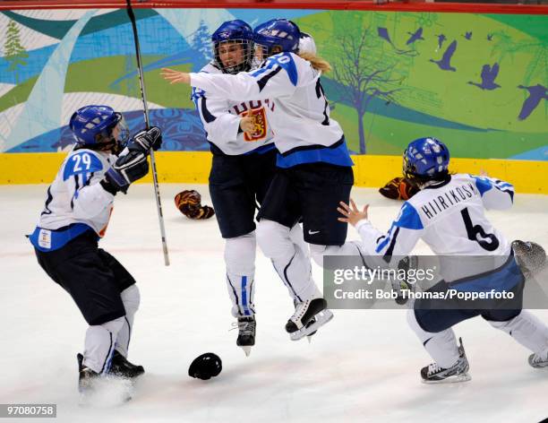 Finland's Saara Touminen celebrates her winning goal with team-mates Karoliina Rantamaki , Saija Sirvio and Jenni Hiirikoski after the ice hockey...