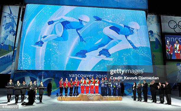 Team Canada receives the silver medal, Team China receives the gold medal and Team USA receives the bronze medal during the medal ceremony for the...