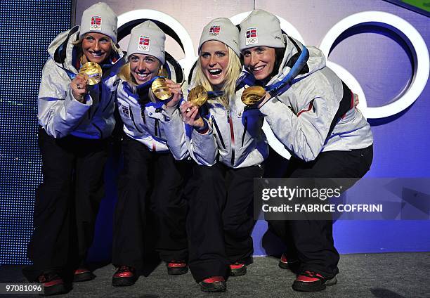 Norway's gold medalists Vibeke W Skofterud, Therese Johaug, Kristin Stoemer Steira and Marit Bjoergen attend the medal ceremony for the women's...