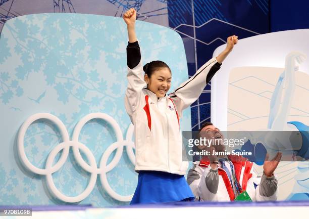 Kim Yu-Na of South Korea celebrates her score in the kiss and cry area with coach Brian Orser in the Ladies Free Skating on day 14 of the 2010...