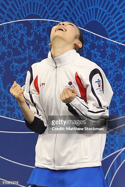Kim Yu-Na of South Korea celebrates her score in the kiss and cry area in the Ladies Free Skating on day 14 of the 2010 Vancouver Winter Olympics at...