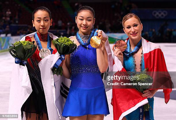 Mao Asada of Japan celebrates the silver medal, Kim Yu-Na of South Korea the gold medal and Joannie Rochette of Canada the bronze medal during the...