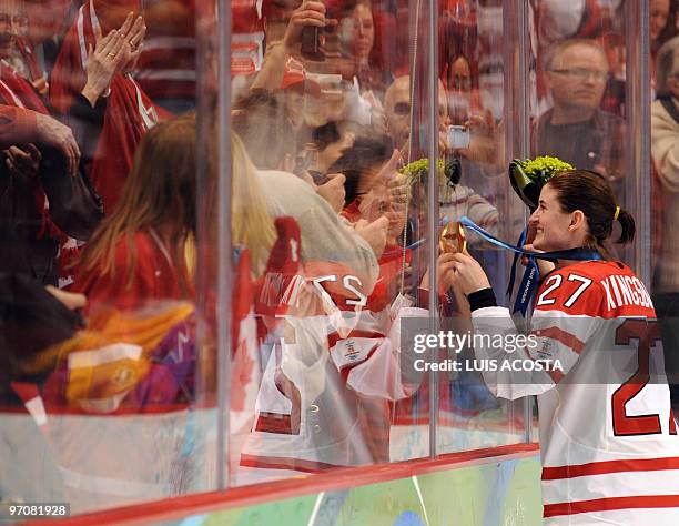 Canada's forward Gina Kingsbury looks at the fans during the medals ceremony in the Woman's Ice Hockey games at the Canada Hockey Place during the...