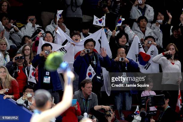Fans from South Korea cheer Kim Yu-Na of South Korea as she receives the gold medal in the Ladies Free Skating during the medal ceremony on day 14 of...